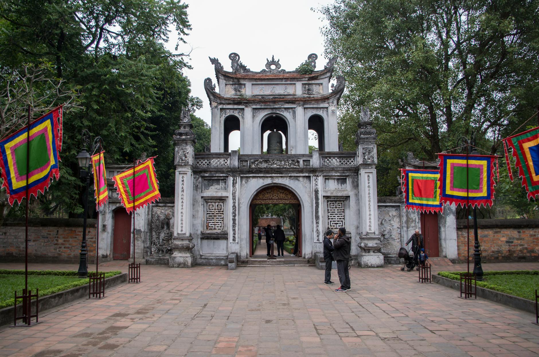 tourists at the main gate of the temple of literature in hanoi