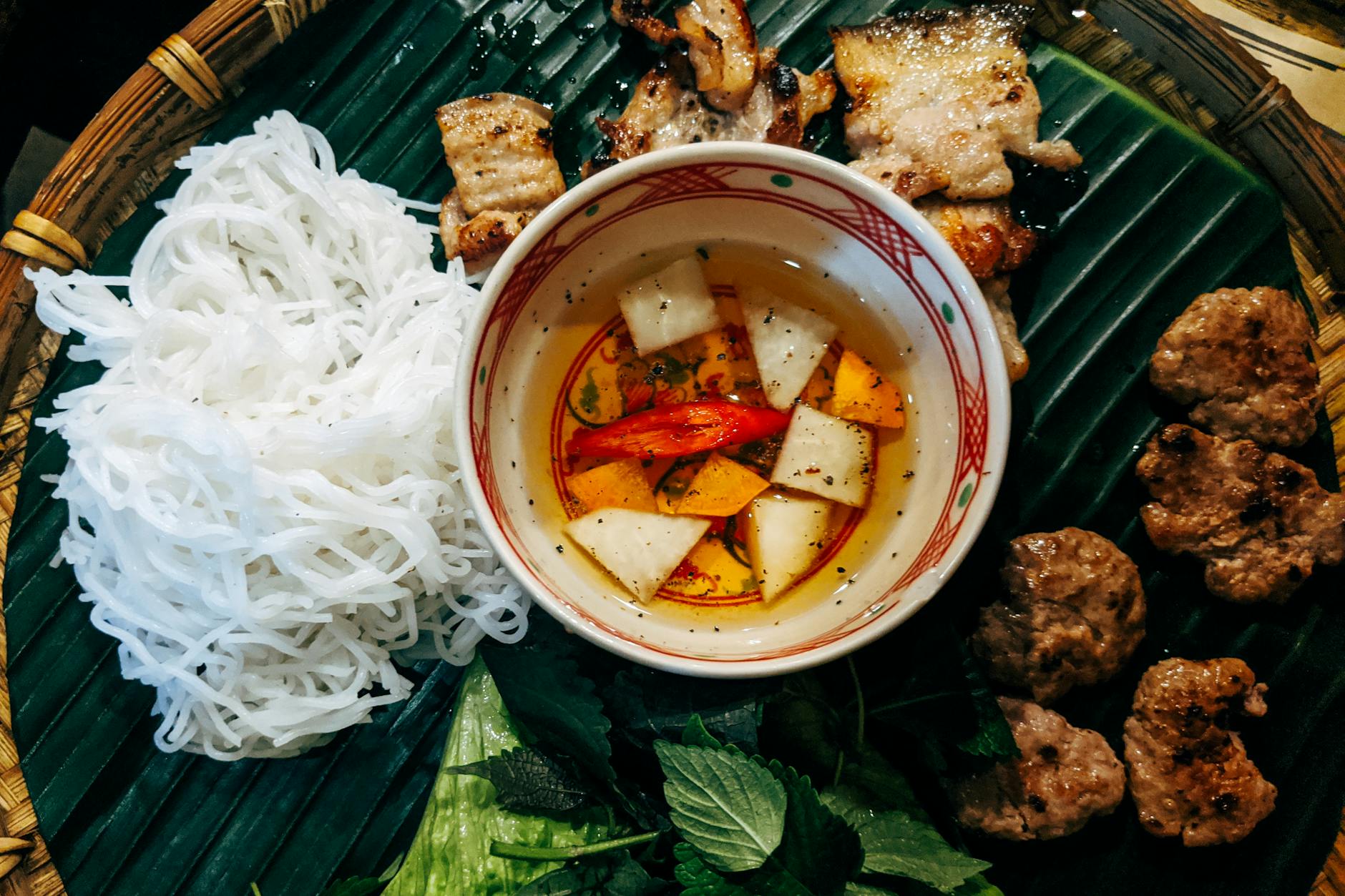 bun cha served on a winnowing basket